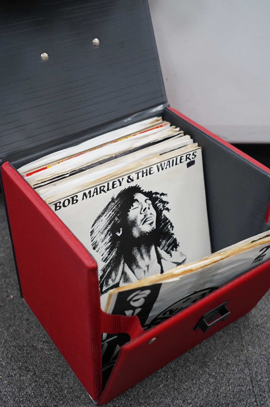 Thirty-six 7” singles, mainly on Two Tone etc. label, artists including; Gangsters, Madness, The Boiler, etc. contained in a singles carry case. Condition - fair